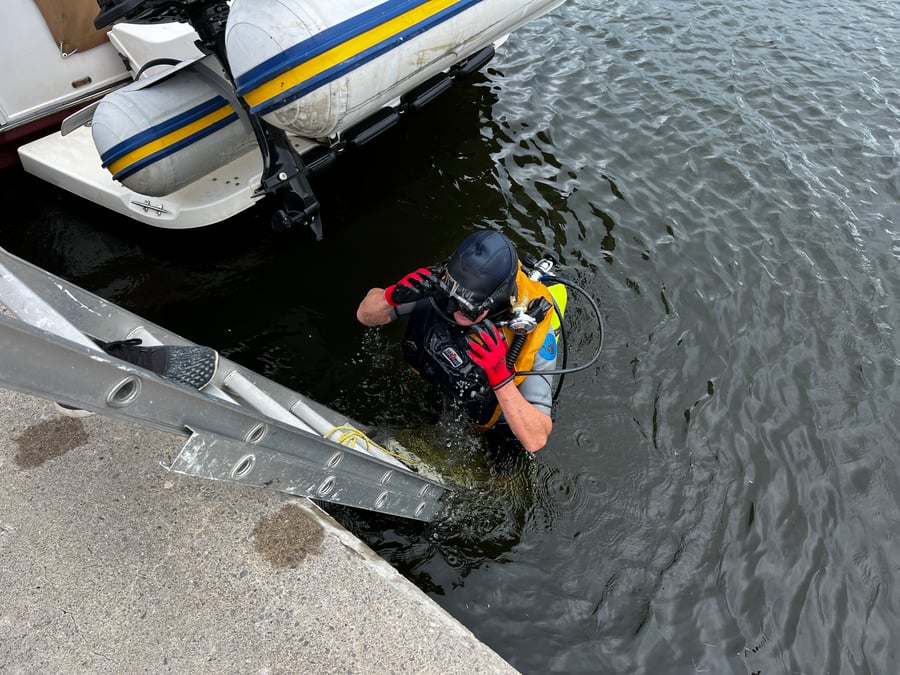Diver at a marina fixing boat