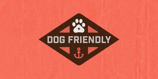 Orange and brown graphic featuring a paw print and an anchor with the words, 'DOG FRIENDLY' 