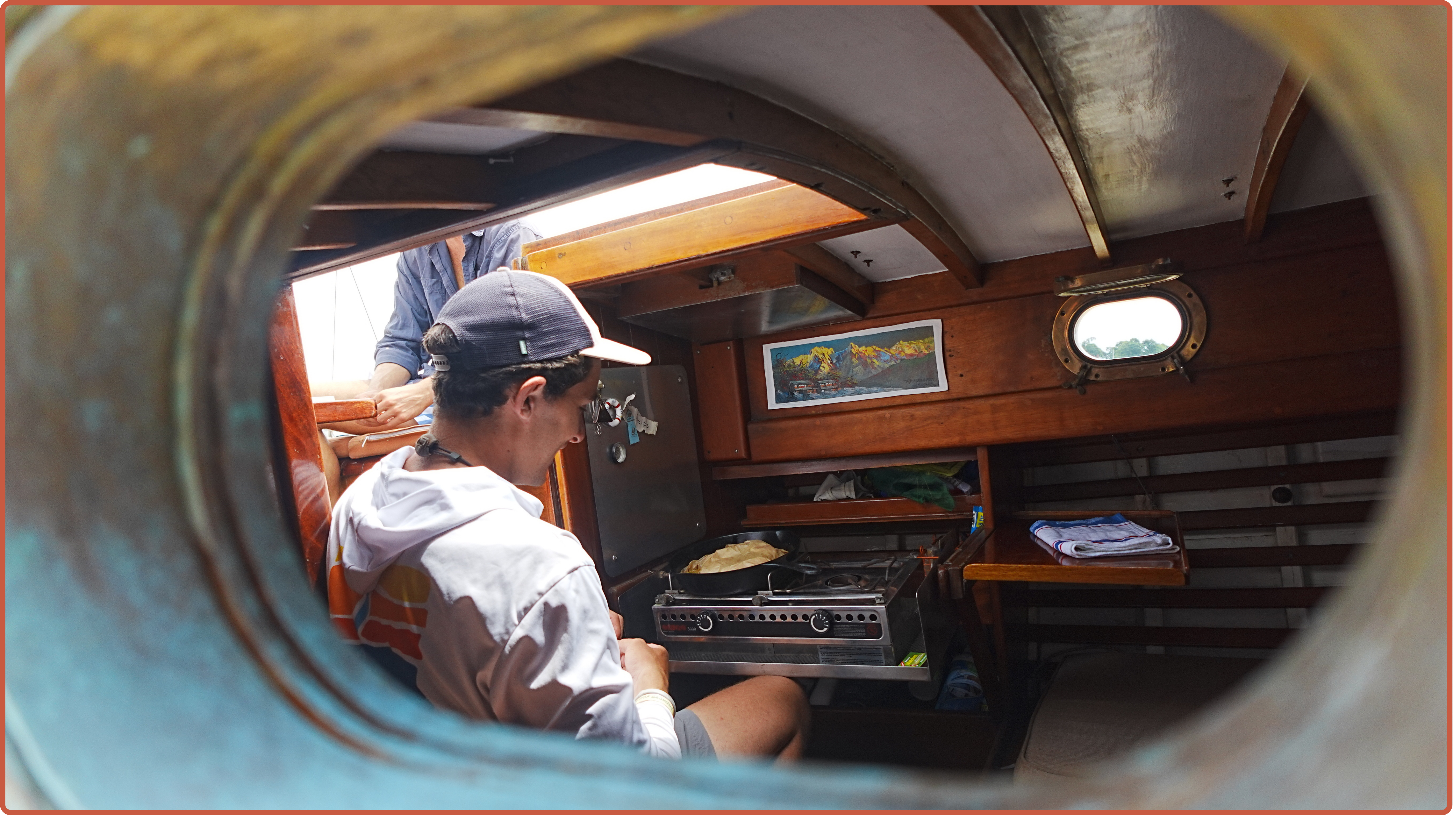 Luc Milam cooking in the galley of SV Holiday